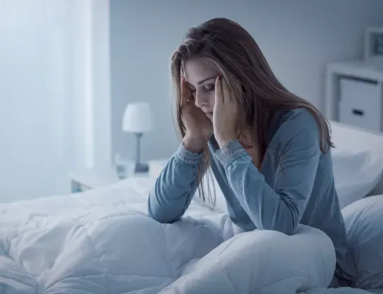woman-with-insomnia-sitting-up-in-bed